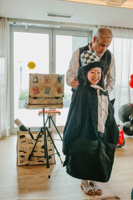 Frank performing a magic trick with a young guest