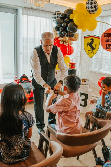 Frank performing a close-up magic trick for a child